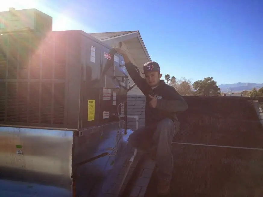 HVAC technician performing Air Duct Cleaning on a rooftop unit in Marbletown